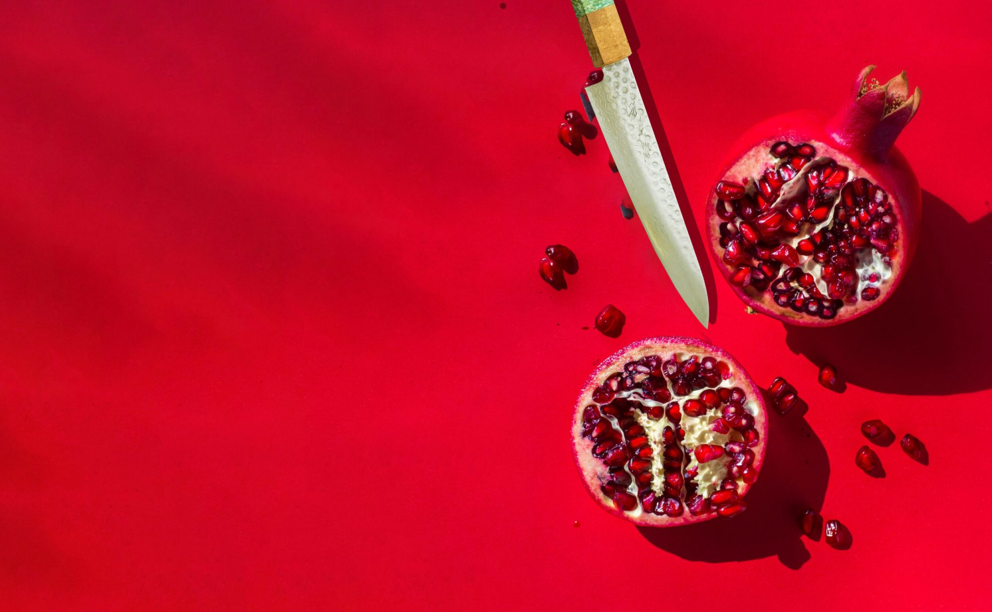 Japanese knife with cut pomegranate