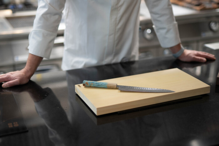sakai kyuba gyuto blue on aomori hiba cutting board