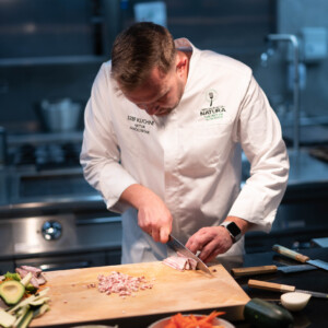 chef cutting bacon with sakai kyuba gyuto - japanese kitchen knives