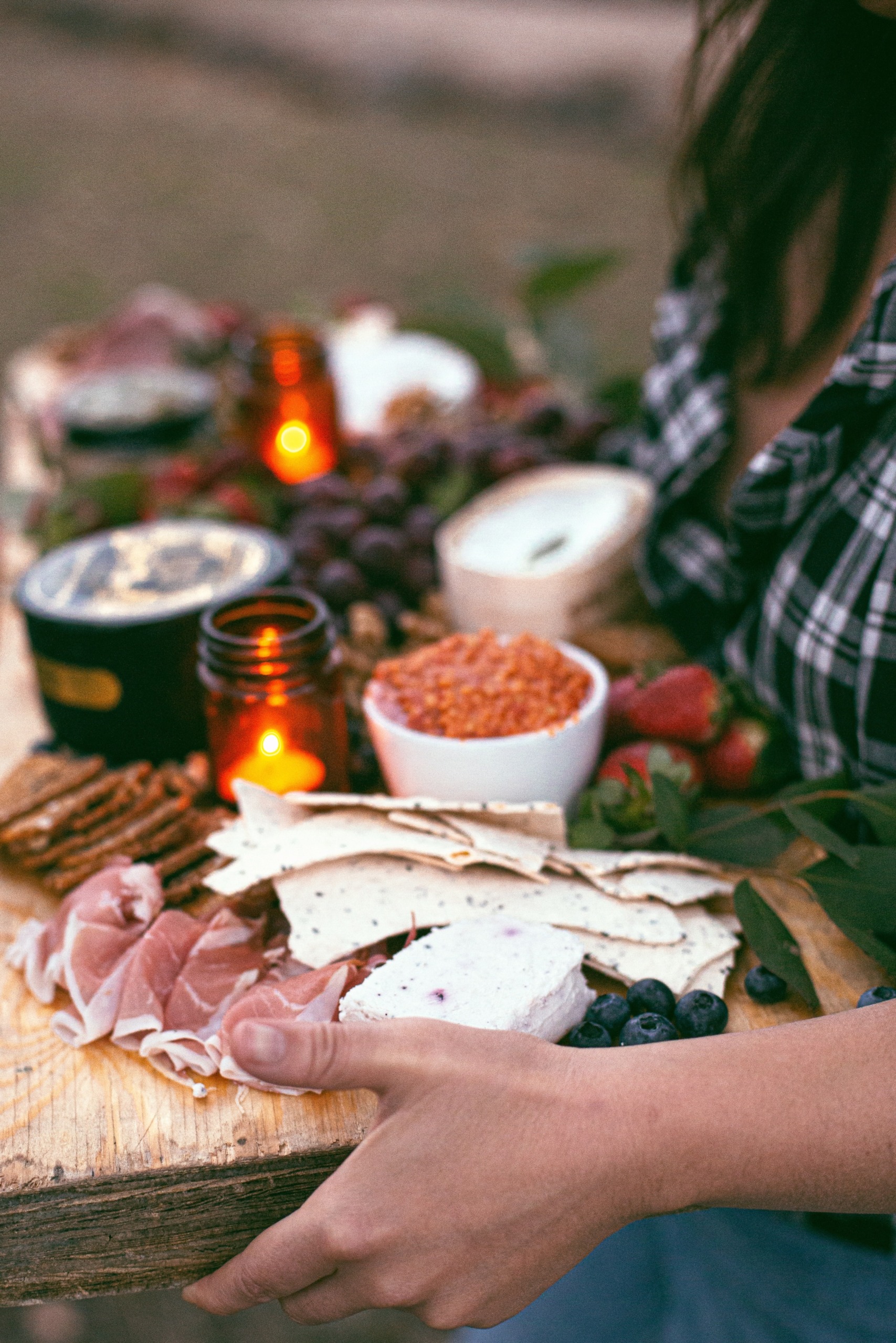 Woman carrying a wooden charcuterie board