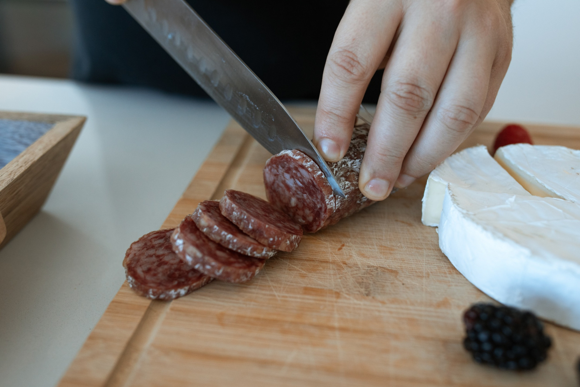 cutting salami pexels