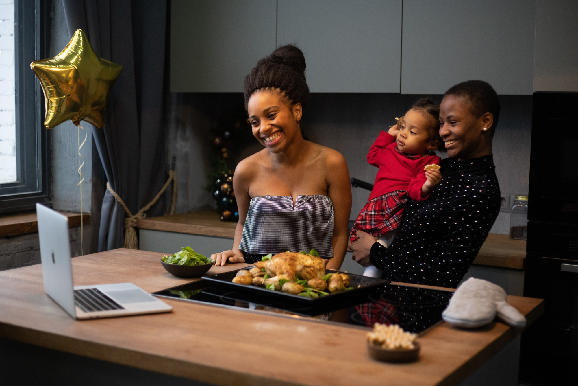 Family cooking in front of laptop