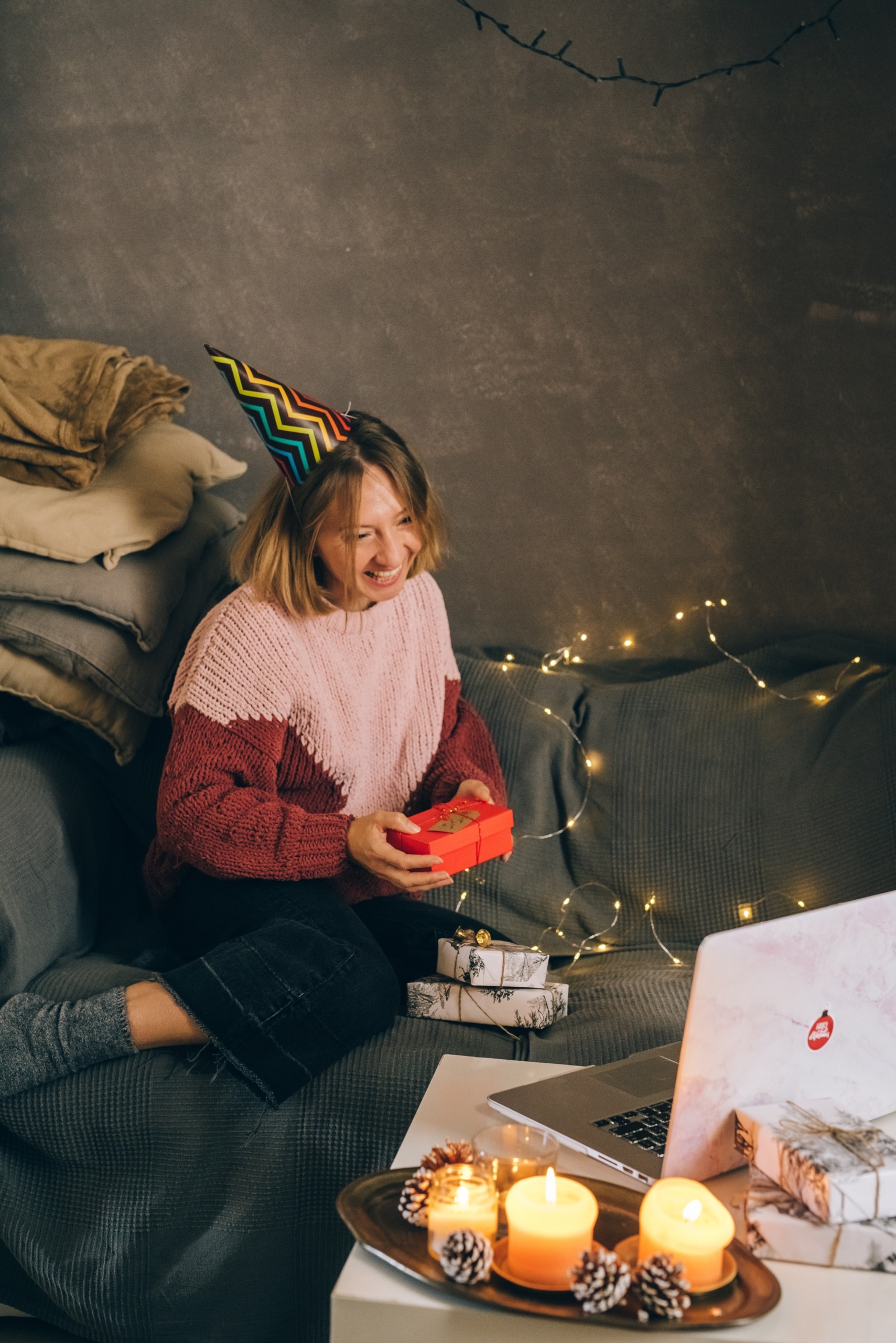 Woman with presents in front of computer