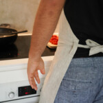 Kitchen Apron - Natural, worn by man tied Kitchen Apron - Natural, worn by man tied