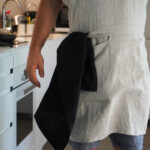 Man wearing Kitchen Apron in natural, hanging kitchen towel Man wearing Kitchen Apron in natural, hanging kitchen towel