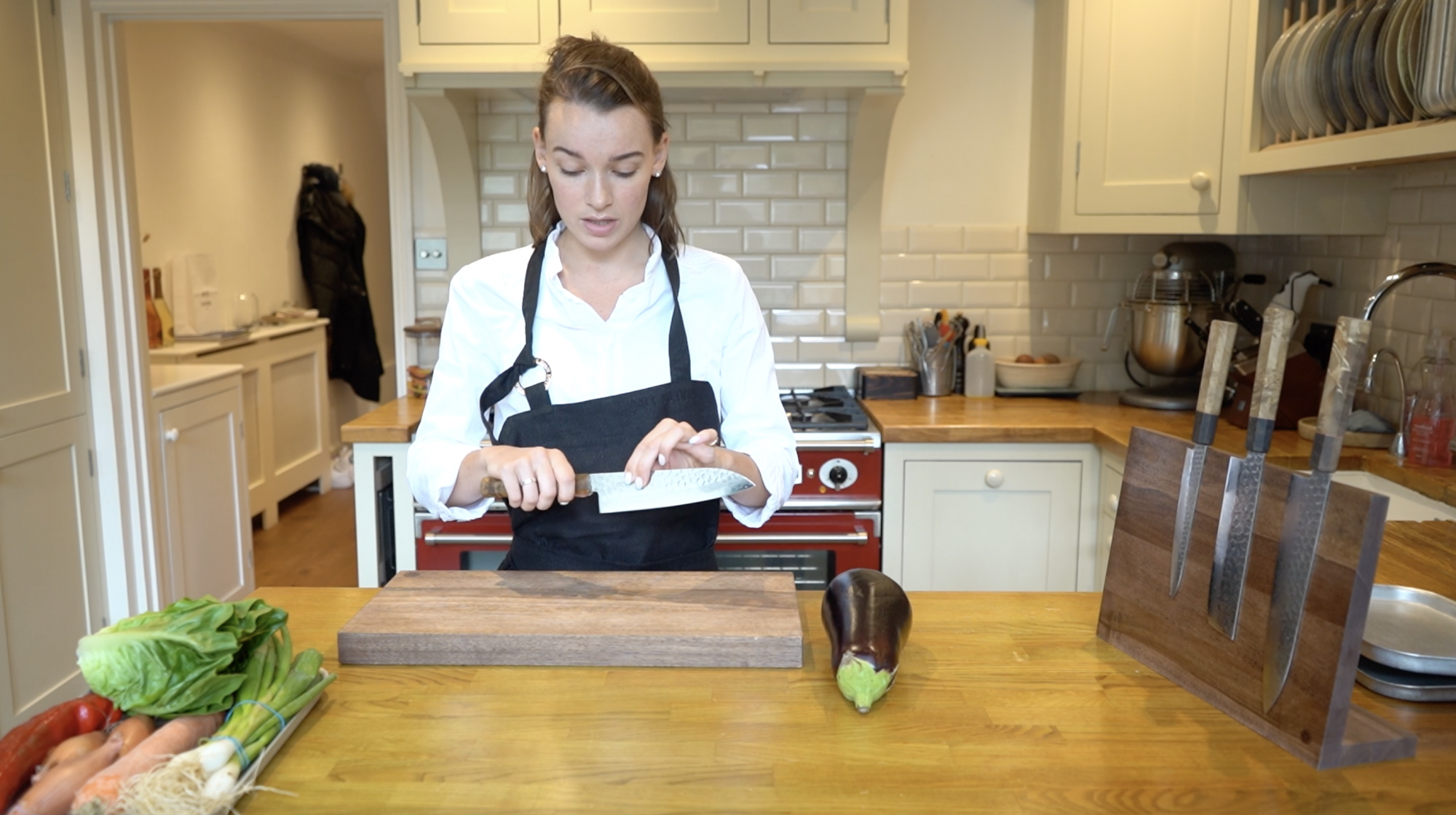 Chef Olivia Burt holding Sakai Kyuba Santoku knife in natural brown